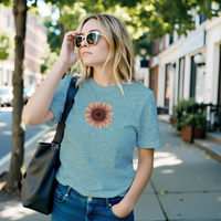 Load image into Gallery viewer, Street Scene Heather Ice Blue: A blonde woman in sunglasses standing on a city street wearing the No. 28 The Evolution Premium Luxury Tee in Heather Ice Blue, featuring a high-contrast vintage botanical sunflower print.