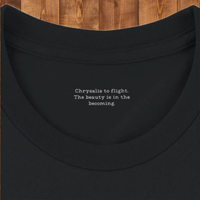 Load image into Gallery viewer, No. 26: Chrysalis to Flight - Close-up of hidden inner collar typography and premium stitching on a high-contrast black premium luxury tee.