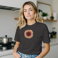 Load image into Gallery viewer, A blonde woman in a modern kitchen wearing the No. 28 The Evolution Premium Luxury Tee in Vintage Black, anchoring the comfortable home-life aesthetic.