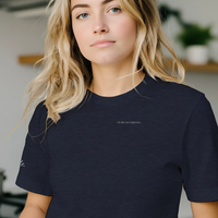 Load image into Gallery viewer, Blonde woman wearing the women's premium sueded cotton 'The Exhale' graphic tee in Navy. Minimalist mental health apparel featuring subtle chest typography and sleeve detail.
