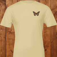 Load image into Gallery viewer, No. 26: Chrysalis to Flight - Flat lay of a soft cream premium luxury tee featuring a vintage botanical butterfly chest graphic.