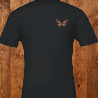 Load image into Gallery viewer, No. 26: Chrysalis to Flight - Flat lay of a high-contrast black premium luxury tee featuring a vintage botanical butterfly chest graphic.
