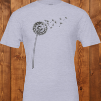 Load image into Gallery viewer, No. 25: The Emergence - Flat lay of a Heather ice blue premium luxury tee featuring a botanical dandelion illustration