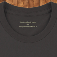 Load image into Gallery viewer, Macro detail of a premium sensory-friendly collar revealing a hidden somatic anchor reading Your feminism is magic, highlighting the bespoke two-pass artisanal print and luxury side-seamed construction.