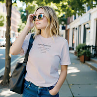 Load image into Gallery viewer, Blonde woman in a modern kitchen wearing the Light pink 'Hopeful Romantic' sueded cotton tee. Minimalist wellness apparel for everyday comfort.
