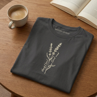 Load image into Gallery viewer, Dark Charcoal Grey t-shirt with white lavender floral line art. "Hopeful Heart, Quiet Mind" aesthetic flat lay setting.
