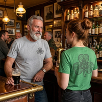 Load image into Gallery viewer, Older man and younger woman talking in an authentic Irish pub. The man wears a heather grey tee with a subtle chest graphic, and the woman wears a heather green tee with a large 301mm back print of a Celtic knot shamrock.