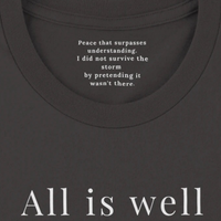 Load image into Gallery viewer, All Is Well shirt in Vintage Black — close-up of inner collar message