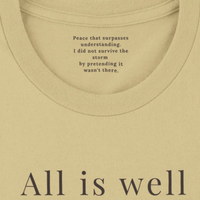 Load image into Gallery viewer, All Is Well shirt in Warm Cream — close-up of inner collar message
