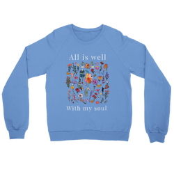 Carolina Blue All Is Well crewneck sweatshirt laid flat, showing the wildflower field with “All is well” above and “With my soul” below in off-white lettering.