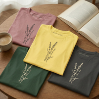 Load image into Gallery viewer, Vital Threads "Worthy of Rest" t-shirt collection palette showing Mauve, Yellow, and Forest Green shirts folded together with open books.