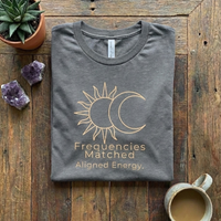 Load image into Gallery viewer, Dark Charcoal Grey t-shirt with gold sun and moon graphic. Minimalist aesthetic flat lay for spiritual apparel.