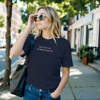 Load image into Gallery viewer, A woman projecting effortless authority walking through a city street in the Big Fan of Human Rights shirt in Heather Midnight Navy — premium side-seamed everyday uniform for the modern advocate.