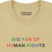 Load image into Gallery viewer, Macro detail of the Big Fan of Human Rights shirt in Soft Cream, highlighting the premium textile weave, pastel chest graphic, and hidden inner collar manifesto reading "The absolute baseline of human decency."