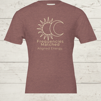 Load image into Gallery viewer, Flat lay of the Frequencies Matched tee in Earth tones (Mauve, Grey, Clay), showcasing the minimalist "Aligned Energy" typography.