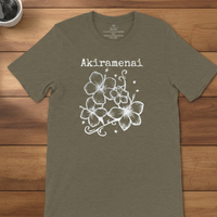 Load image into Gallery viewer, Military green Vital Threads t-shirt flat lay on a wood background featuring the white Akiramenai "unyielding spirit" graphic.