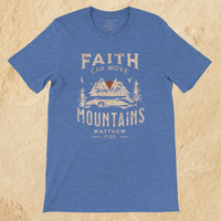 Load image into Gallery viewer, Flat lay of the Heather Columbia Blue Faith can Move Mountains shirt on a tan background, showing the full front mountain graphic.