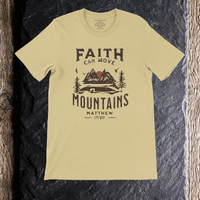 Load image into Gallery viewer, Flat lay of the Warm Cream Faith can Move Mountains shirt on a dark slate background, showing the full front mountain graphic.