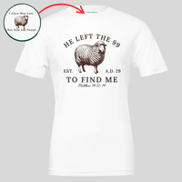 Load image into Gallery viewer, White He Left the 99 to Find Me shirt, flat front view showing the engraved sheep with "He left the 99" arched above, "To find me" and Matthew 18:12-14 below, with an inset close-up of the inner collar message.
