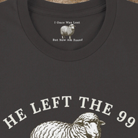Load image into Gallery viewer, Close-up of the He Left the 99 to Find Me shirt in Dark Grey Heather, showing the hidden inner collar message "I Once Was Lost, But Now Am Found" above the front sheep graphic.