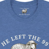 Load image into Gallery viewer, Close-up of the He Left the 99 to Find Me shirt in Heather Blue, showing the hidden inner collar message "I Once Was Lost, But Now Am Found" above the front sheep graphic.