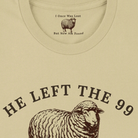 Load image into Gallery viewer, Close-up of the He Left the 99 to Find Me shirt in Warm Cream, showing the hidden inner collar message "I Once Was Lost, But Now Am Found" above the front sheep graphic.