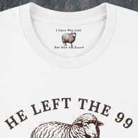 Load image into Gallery viewer, Close-up of the He Left the 99 to Find Me shirt in White, showing the hidden inner collar message "I Once Was Lost, But Now Am Found" above the front sheep graphic.