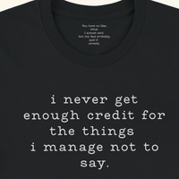 Load image into Gallery viewer, I never get enough credit shirt in Black — collar detail revealing hidden message: You have no idea what I almost said but my face probably said it already