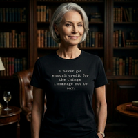 Load image into Gallery viewer, I never get enough credit shirt in Black — silver-haired woman in library setting, premium combed ring-spun cotton tee.