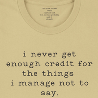 Load image into Gallery viewer, I never get enough credit shirt in Soft Cream — collar detail revealing hidden message: You have no idea what I almost said but my face probably said it already.