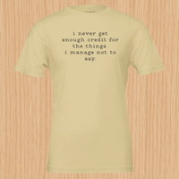 Load image into Gallery viewer, I never get enough credit shirt in Soft Cream — front flat lay, typewriter serif lowercase graphic tee