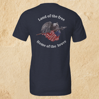 Load image into Gallery viewer, Back flat lay of the Land of the Free, Home of the Brave shirt in Heather Midnight Navy, featuring an eagle gripping a spear-mounted flag with ‘Land of the Free’ and ‘Home of the Brave’ arched in Alabaster ink.
