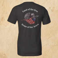 Load image into Gallery viewer, Back flat lay of the Land of the Free, Home of the Brave shirt in Vintage Black, featuring an eagle gripping a spear-mounted flag with ‘Land of the Free’ and ‘Home of the Brave’ arched in Alabaster ink.