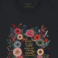 Load image into Gallery viewer, A macro detail shot of the No. 33 The Calling premium luxury tee in black, revealing the hidden inner collar somatic anchor that reads Blessed is she who believed, highlighting the artisanal print quality.