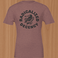 Load image into Gallery viewer, Flat lay of the No. 35 Radicalized By Basic Decency shirt in Heather Mauve — dark charcoal crow graphic on premium combed ring-spun cotton, a wearable reminder to champion fundamental human respect.