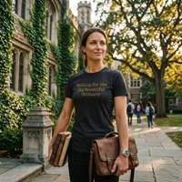 Load image into Gallery viewer, Someone on a university campus wearing the No. 36 Big Beautiful Obituary shirt in Black — premium side-seamed tee with vintage gold typewriter typography and an unapologetic everyday standard.