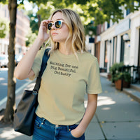 Load image into Gallery viewer, Someone wearing the No. 36 Big Beautiful Obituary shirt in Soft Cream — a premium everyday standard effortlessly bridging high-status minimalism with a deadpan observational statement.