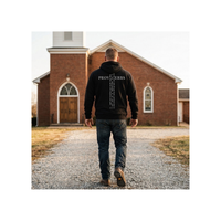Load image into Gallery viewer, Man seen from behind in the Black Proverbs 3:5-6 hooded sweatshirt, walking a gravel path toward a brick church.

