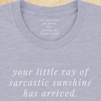 Load image into Gallery viewer, Product flat lay — Your Little Ray of Sarcastic Sunshine Has Arrived heather blue premium graphic tee by Vital Threads.