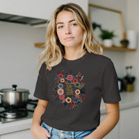 Load image into Gallery viewer, Woman in a modern kitchen wearing the Trust in the Lord shirt in Black, botanical floral wreath design on the front.