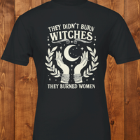 Load image into Gallery viewer, Flatlay presentation of a quiet luxury feminist graphic tee in dark charcoal, featuring high-contrast vintage botanical hands and a celestial crescent moon illustration.