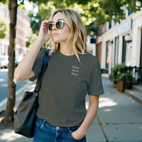 Load image into Gallery viewer, Blonde woman wearing the Asphalt dark grey No. 11 The Trilogy premium luxury tee on a city street.