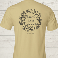 Load image into Gallery viewer, Back view of the Soft Cream yellow No. 11 The Trilogy premium luxury tee displaying the botanical wreath design.