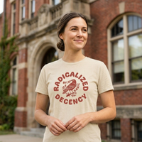 Load image into Gallery viewer, Woman confidently walking in a curated urban streetscape wearing the Radicalized By Decency premium natural cotton graphic tee. Features a vintage avian and botanical illustration. Quiet luxury activist apparel and everyday uniform for women.