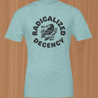 Load image into Gallery viewer, Flat lay of the Radicalized By Decency women's luxury graphic tee in heather ice blue. Showcasing the premium side-seamed drape, breathable ring-spun cotton texture, and deep espresso two-pass artisanal print