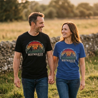Load image into Gallery viewer, Man wearing the Waymaker shirt in Black holding hands with a woman wearing the Waymaker shirt in Heather True Royal, outdoors in an open field.