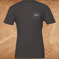 Load image into Gallery viewer, We The People premium tee ghost lay front view in charcoal showing the 1776 Betsy Ross star circle left-chest graphic on a premium ring-spun cotton blank
