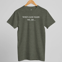 Load image into Gallery viewer, Studio hanger shot of the When God Made Me shirt in Heather Military Green, front "When God Made Me, He..." text visible.
