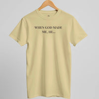Load image into Gallery viewer, Studio hanger shot of the When God Made Me shirt in Soft Cream, front "When God Made Me, He..." text visible.