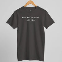 Load image into Gallery viewer, Studio hanger shot of the When God Made Me shirt in Vintage Black, front "When God Made Me, He..." text visible.